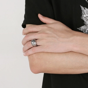 Macro detail of men's vintage titanium steel ring with textured hammered sphere surface