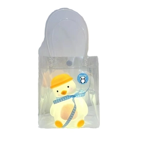 Cartoon glowing duck night light with blue bow tie in transparent gift bag with handle