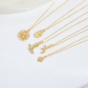 Golden sun flower and cowboy boot pendant necklaces set on white silk background