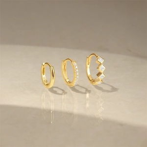 Detailed set of three gold S925 earrings with plain hoops and sparkling zircon accents