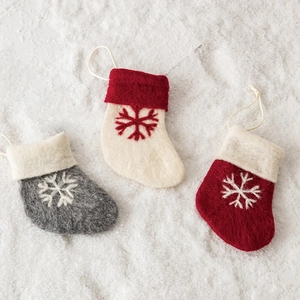 Set of three felt Christmas stockings with snowflake embroidery on snowy background