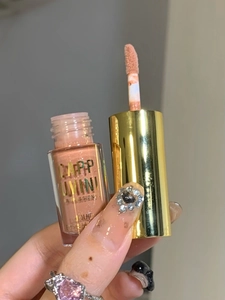 Detail of liquid eyeshadow applicator in nude pink shade with elegant gold cap