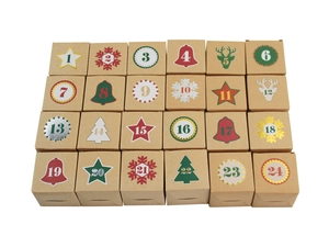 Flat lay of 24 Kraft paper advent calendar boxes with colorful 1-24 number stickers
