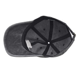 Detail of grey washed cotton baseball cap showing internal stitching and adjustable strap