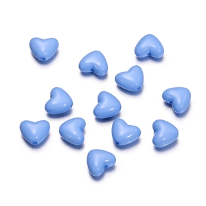 Close-up of light blue heart-shaped acrylic beads with pre-drilled holes for DIY jewelry