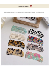 Flat lay of marble pattern acetate cat combs in assorted colors and stylish textures