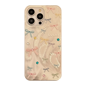 Sparkling beige iPhone case with colorful bows, crystals, and Lucky text design