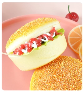 Macro shot of realistic slow rebound squishy burger toy with sesame seeds on pink tray