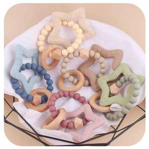 Star-shaped silicone and wooden baby teething ring with colorful beads in a basket