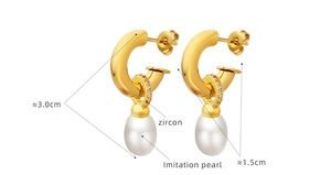 Detail view of gold C-shaped earrings with zircon accents and teardrop imitation pearls