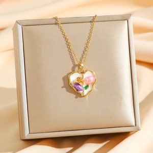 Vintage heart tulip pendant necklace with fresh water pearls on a gold jewelry gift box