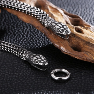 Vintage stainless steel snake bone chain with double head clasps on leather background