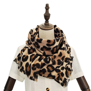 Soft faux cashmere scarf featuring a classic brown and black leopard print with fringe