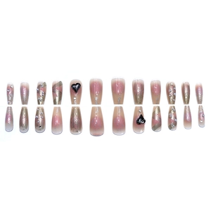 Long coffin press-on nails with nude gradient, 3D black hearts and golden wave details