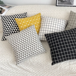 Nordic geometric cotton linen pillowcases in yellow and grey set on soft sofa