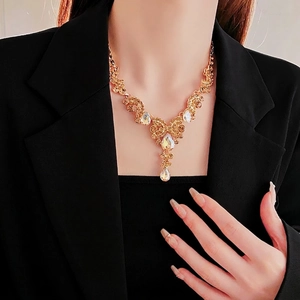 French style gold hollow teardrop necklace with champagne crystals on model