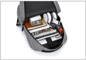 Detail view of large capacity gray backpack showing organized compartments for laptop and gear