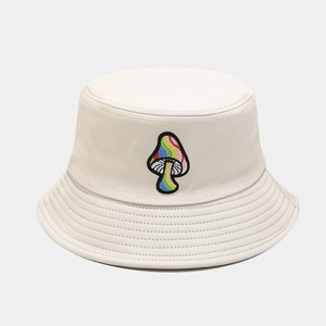 Close-up of rainbow mushroom embroidery on off-white canvas bucket hat detail