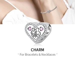 Macro shot of S925 silver heart charm with pink stones and sparkling crystal inlay