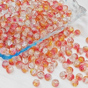 Macro shot of 6mm and 8mm crackle glass beads in pink and gold for DIY jewelry