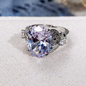 Macro detail of oval cubic zirconia ring with S925 butterfly hollow pattern band
