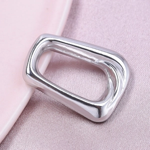 Detailed macro view of polished silver stainless steel rectangular jewelry pendant piece