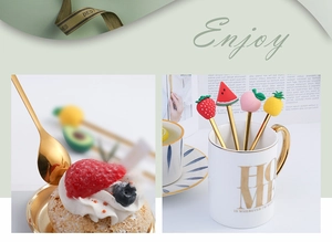 Detailed macro view of creative gold stainless steel fruit spoons and forks in a white mug