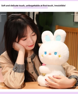 Close-up of white plush bunny doll showing soft texture and cute star eye details