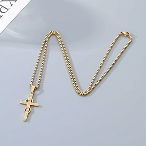 Macro detail of a gold cross necklace with infinity design and sparkling zircons
