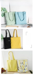 Detail of minimalist canvas tote bags with Geometry Simplicity woven label and long straps