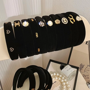 Detail showing vintage black velvet headbands with golden motifs and pearls