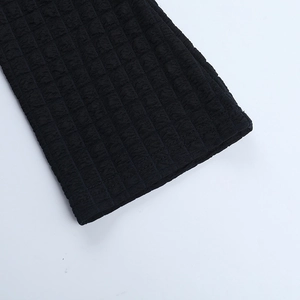Close-up of black checkered texture fabric with embossed pattern for backless tops