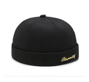 Detail of golden Stunning embroidery on a black cotton docker hat with side view focus