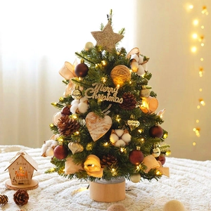 Mini pre-lit snow-flocked Christmas tree with red balls and pine cones on wood base