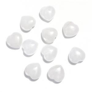 Flat lay of white heart-shaped crystals made of polished natural opal gemstones