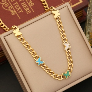 Detail of gold butterfly necklace featuring mother-of-pearl and malachite inlays