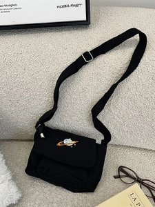 Minimalist black canvas crossbody bag with colorful planet embroidery and adjustable strap