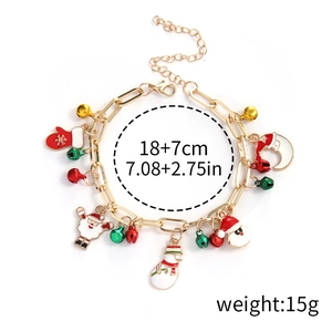 Detail view of Christmas charm bracelet with snowman, Santa, and bells on gold chain