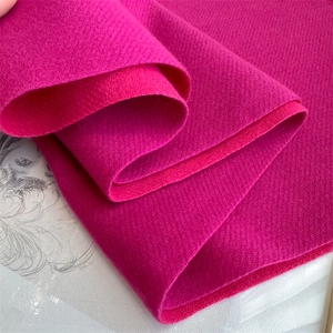 Close-up of thick fuchsia herringbone cashmere scarf fabric with soft texture