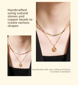 Detail of layered handmade natural stone necklace with gold sun eye pendant on neck