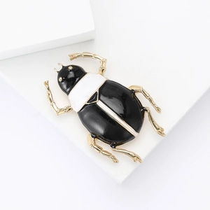 Elegant gold enamel beetle brooch for men and women with black and white shell finish