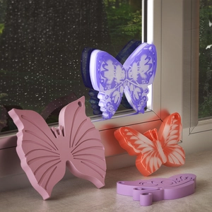 Detailed view of translucent butterfly ornaments with intricate glowing textures and colors