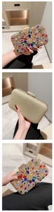 Detailed view of rectangular evening clutch featuring colorful rhinestones and gold finish