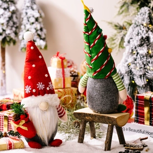 Christmas gnomes with red and green hats in a snowy scene with festive miniature trees