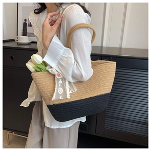 Detail of two-tone woven tote bag with lace ribbon and tulips in a minimalist setting