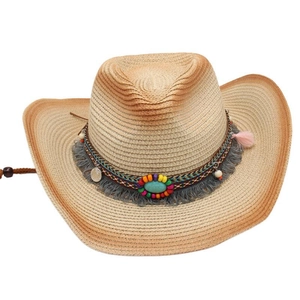 Close-up of woven straw cowboy hat with turquoise stone and colorful fringe detail