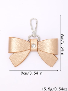 Detail of 9cm golden leather bow keychain with rhinestone and weight dimensions
