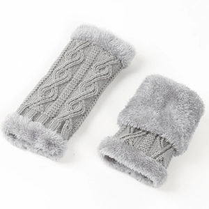 Détail de mitaines en maille torsadée grise avec bordure en fausse fourrure pelucheuse