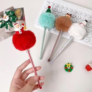 Detail of Christmas plush ball pens featuring Santa, reindeer, and snowman cartoon toppers