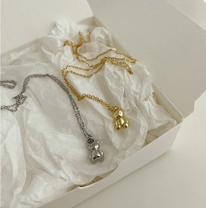 Detailed close-up of 925 sterling silver bear pendants in gold and silver finishes